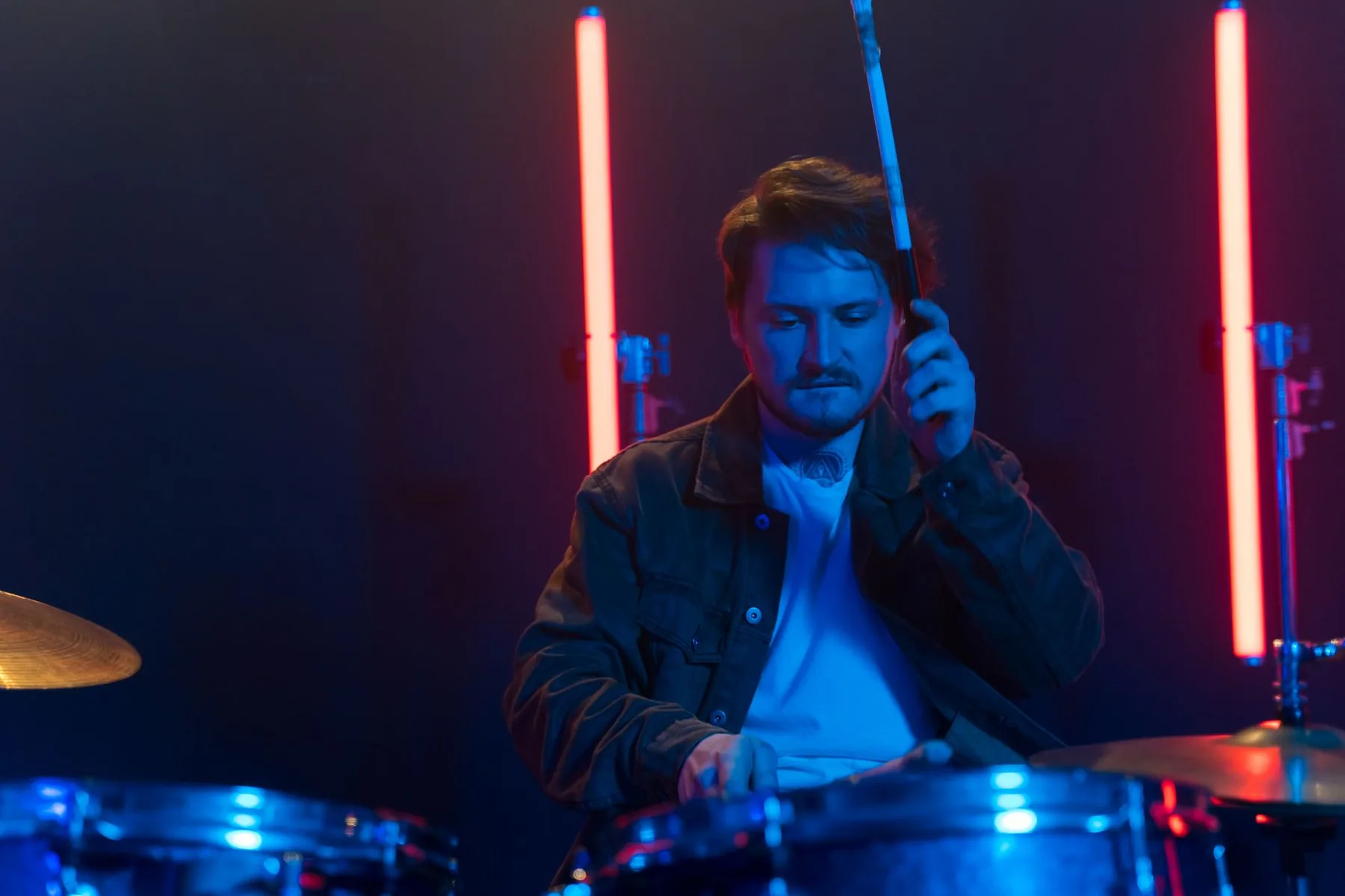 Drummer playing under stage lights