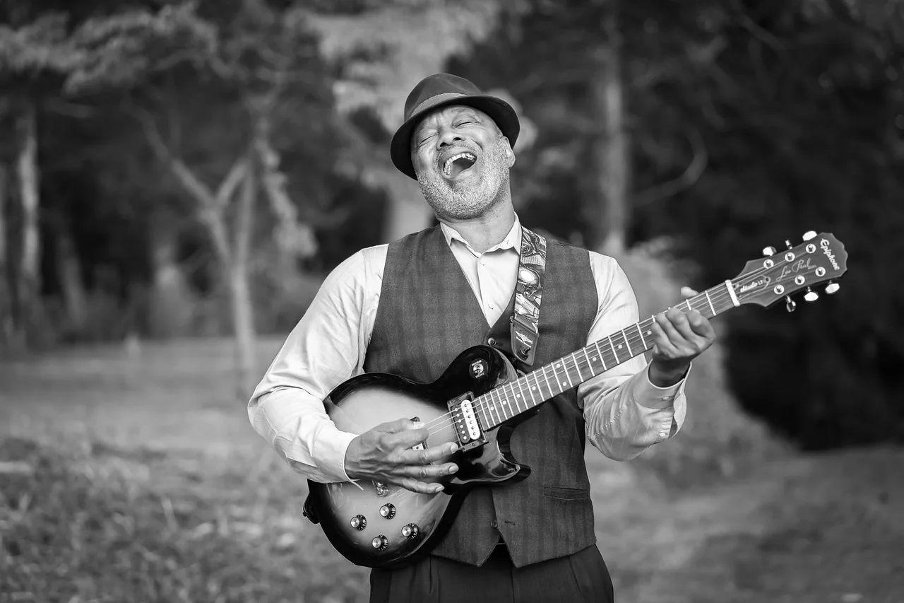 Vintage folk guitarist outdoors Vintage folk guitarist outdoors
