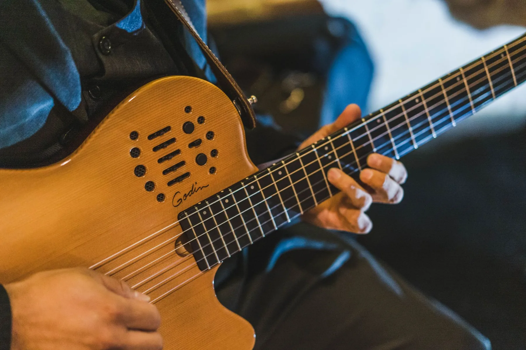 Musician playing a folk guitar Musician playing a folk guitar