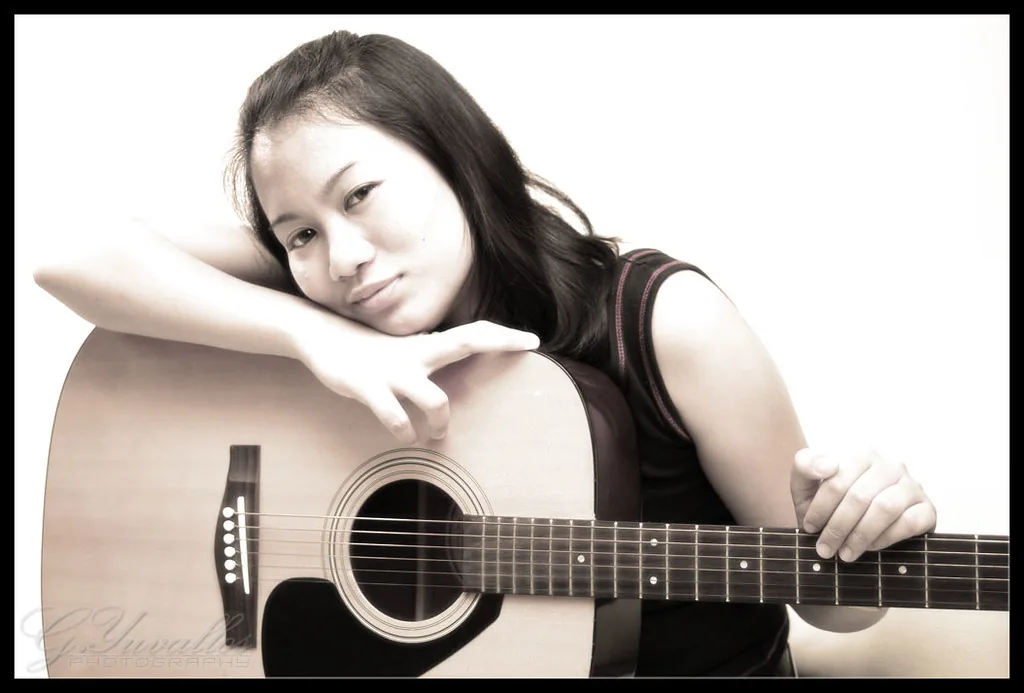 Female musician with a folk acoustic guitar Female musician with a folk acoustic guitar