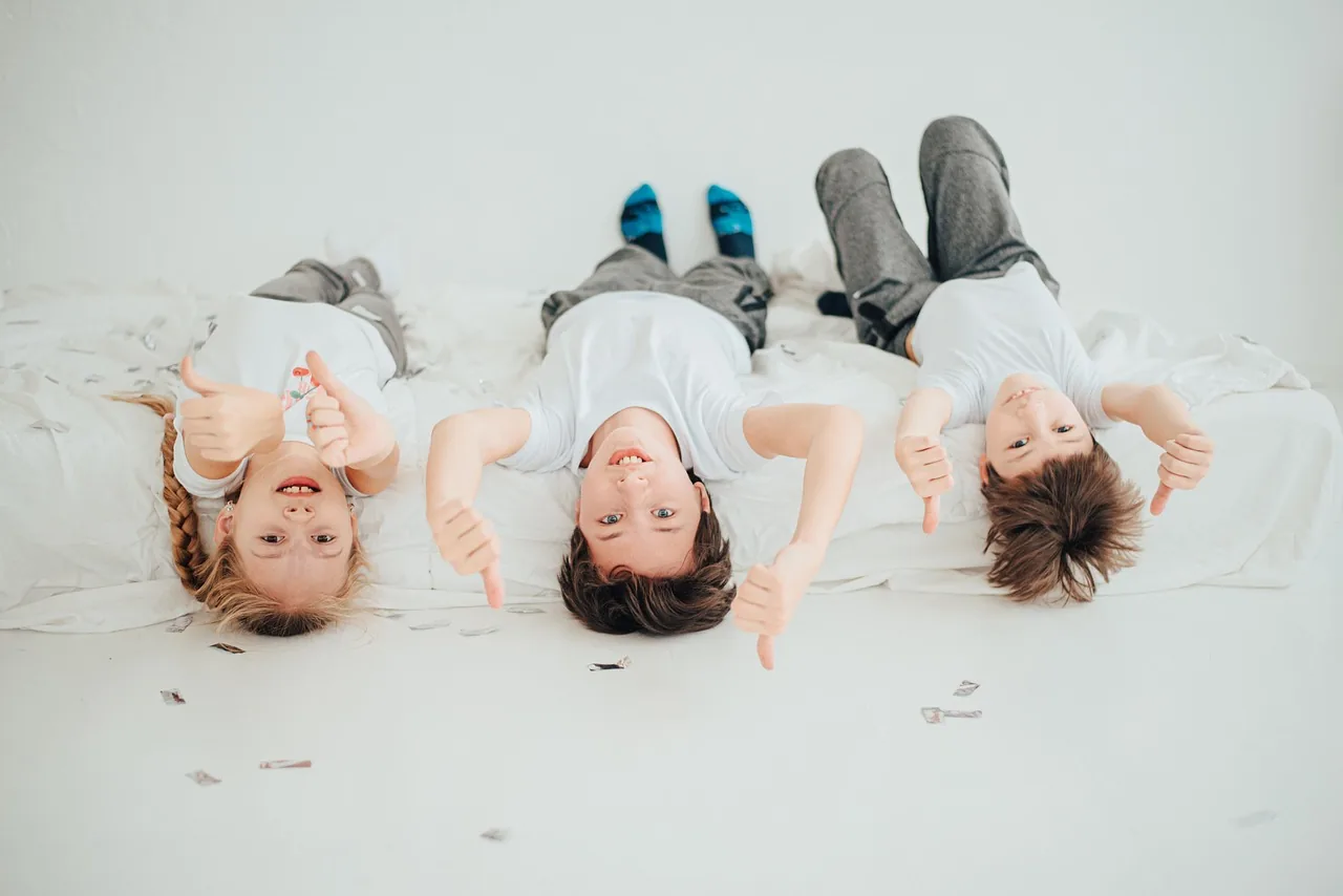Three children sitting together on a sofa