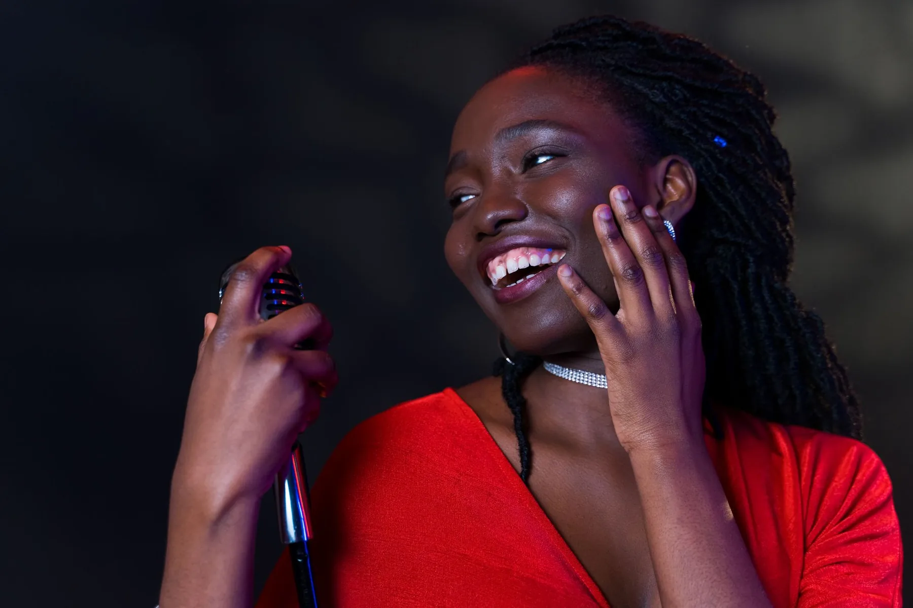 Young female singer onstage at a microphone Young female singer onstage at a microphone