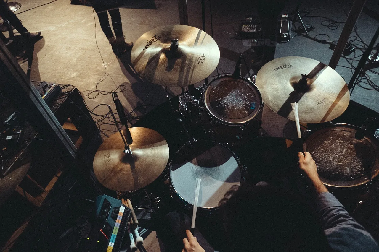 Drummer playing an acoustic drum kit Drummer playing an acoustic drum kit